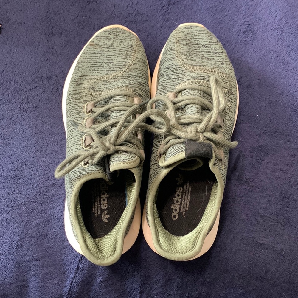 Green Adidas athletic shoes